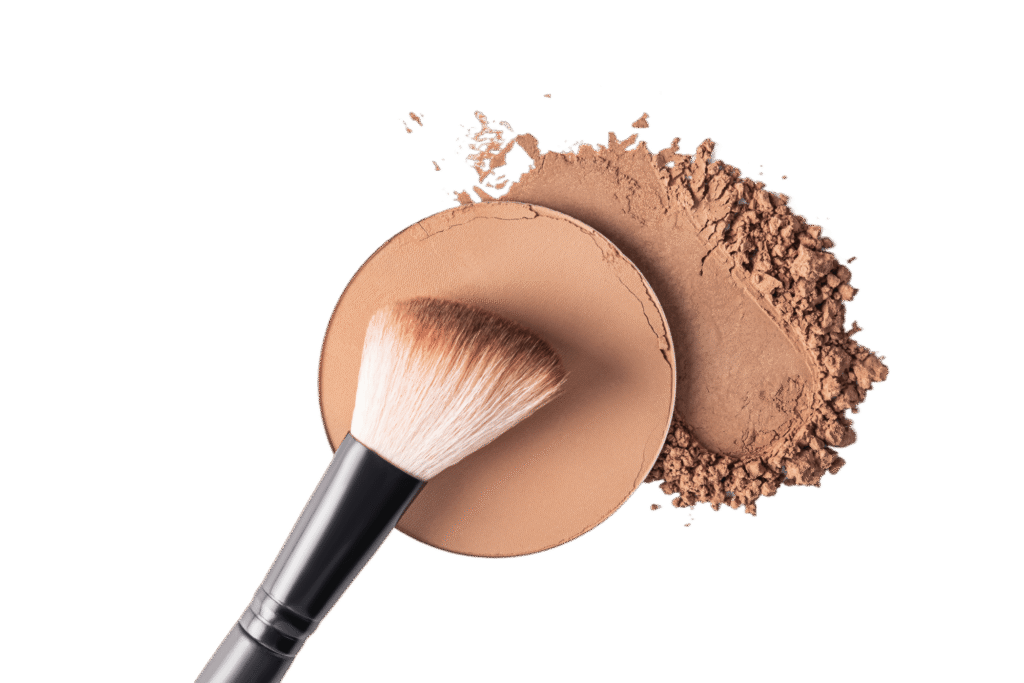 A makeup brush rests on a pressed powder compact with some loose powder scattered nearby, much like the careful touch Bristol flat roof repairs experts bring to their craft.